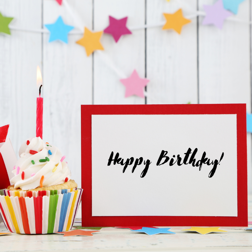 happy birthday sign with a cupcake and candle and decorations