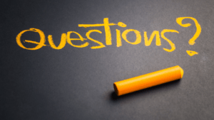 the word "questions" written on a blackboard