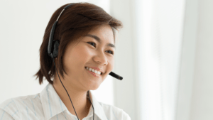 woman smiling while wearing a headset with a microphone